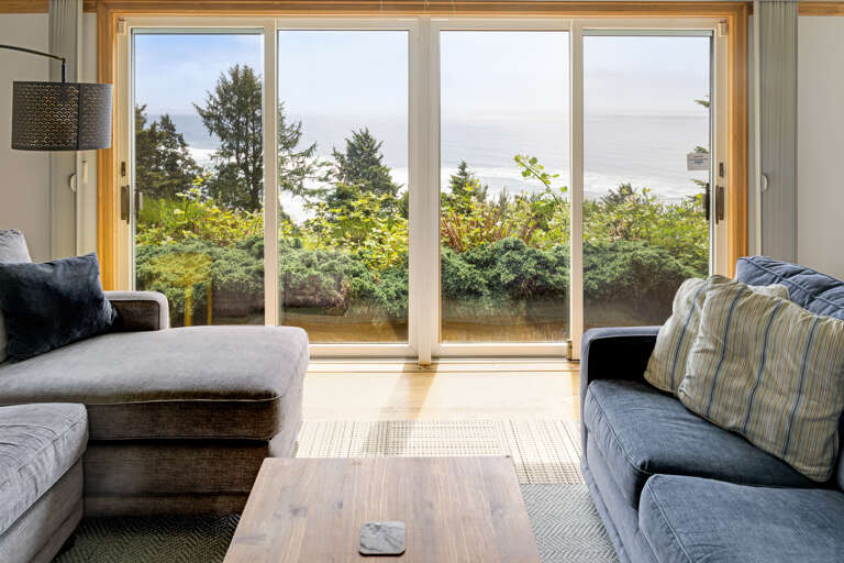 The living area on the main floor is open and expansive and offers a side reading room with desk and comfy chair, wood fireplace (wood not provided), comfortable sleeper sofa with lounge chair, Flat screen with cable TV,  and incredible ocean views.