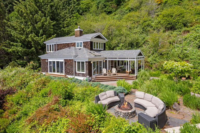 Outdoor area with flowers, fenced yard, Firepit with lounge seating, Picnic table and incredible views day or night. 