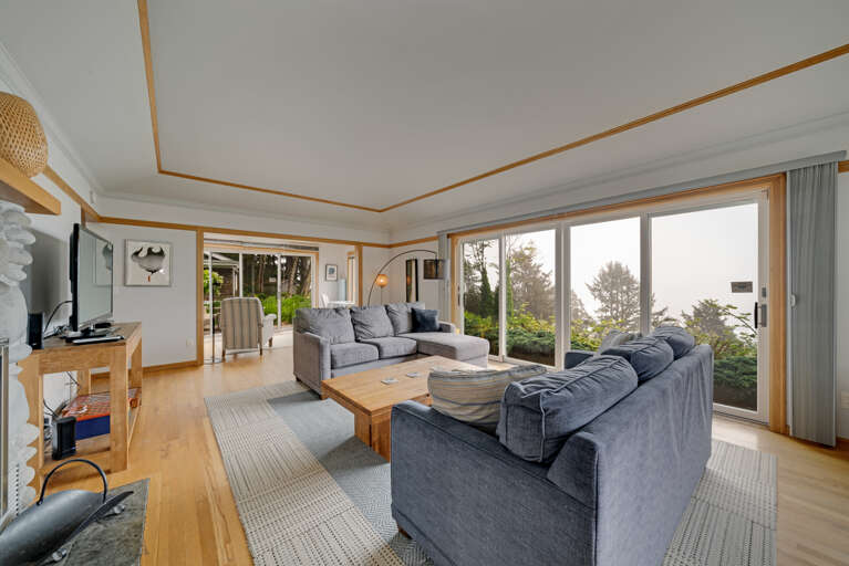 The living area on the main floor is open and expansive and offers a side reading room with desk and comfy chair, wood fireplace (wood not provided), comfortable sleeper sofa with lounge chair, Flat screen with cable TV,  and incredible ocean views.