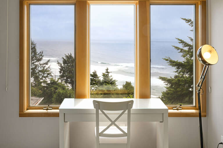 Master bedroom with a king bed, desk area, lounging chair, walk in closet, and master bath with sit down shower and dual sinks with spectacular views. 