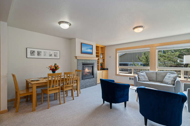 Open dining, kitchen and living space with gas fireplace, and access to upper deck area.  Open dining, kitchen and living space with gas fireplace, and access to upper deck area.