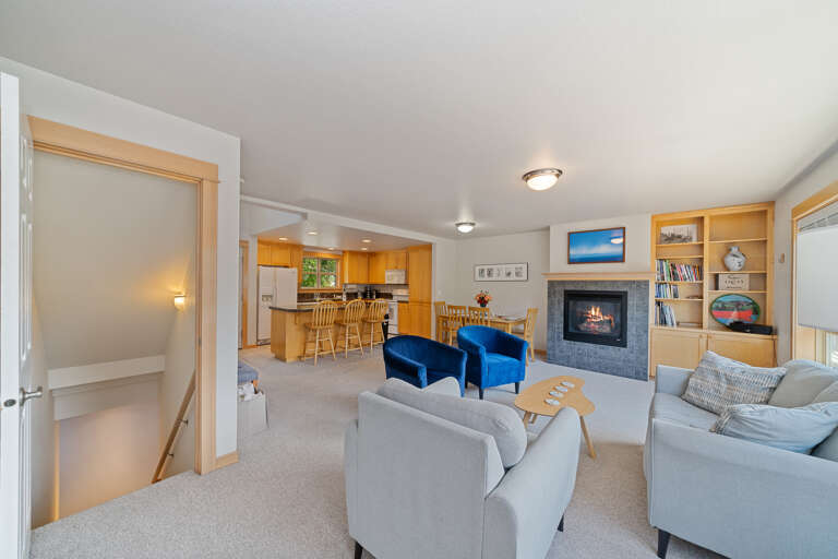 Living area with books, games, gas fireplace, and access to upper deck area.  Living area with books, games, gas fireplace, and access to upper deck area.