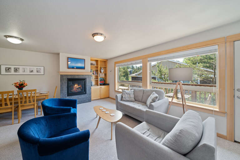 Living area with books, games, gas fireplace, and access to upper deck area.  Living area with books, games, gas fireplace, and access to upper deck area.