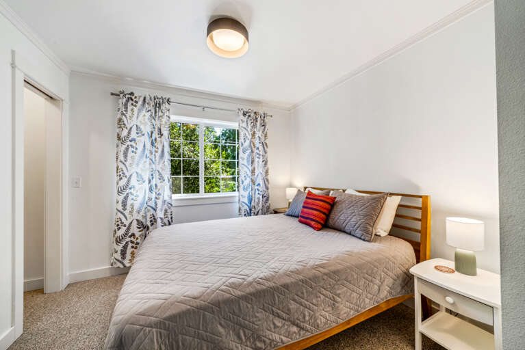 2nd story 2nd bedroom with a queen bed with Roku TV streaming