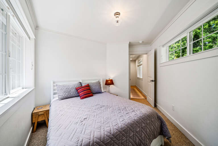 2nd story 3rd bedroom with a queen bed