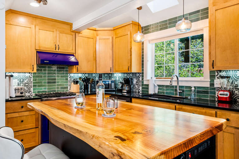 Open Living area with fully equipped kitchen including a Viking Gas range, Breakfast Bar, Dishwasher, Microwave