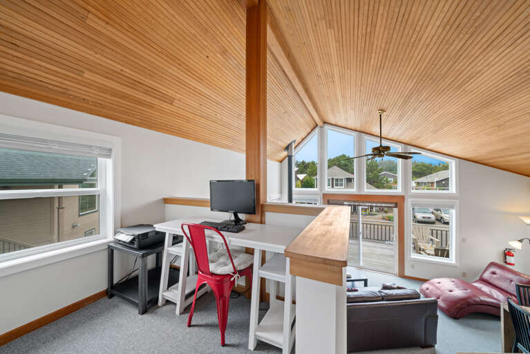 Loft with TV, Sofa bed, office space with monitor, keyboard, and printer.  