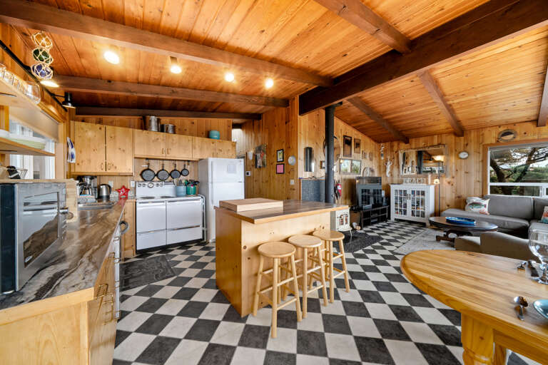 Open living area with fully equipped kitchen, dining, and living. 