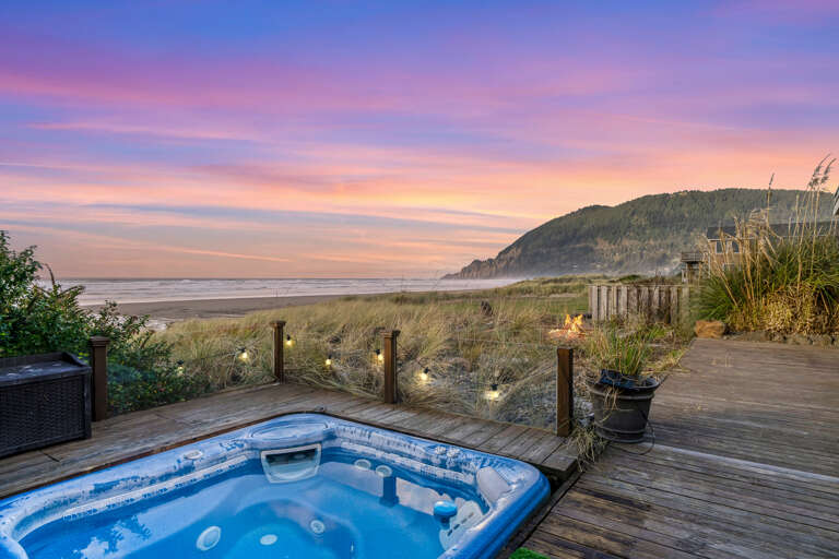 hot tub and firepit facing the ocean and mountains.