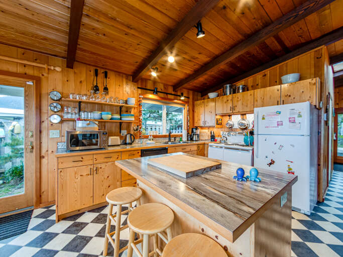 fully stocked kitchen with island and 3 additional seats