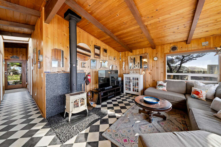 Living room with smart TV, woodstove, and ocean view