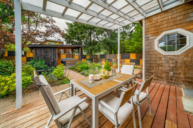 Fenced back yard garden with firepit, hot tub, sauna, covered outdoor dining area