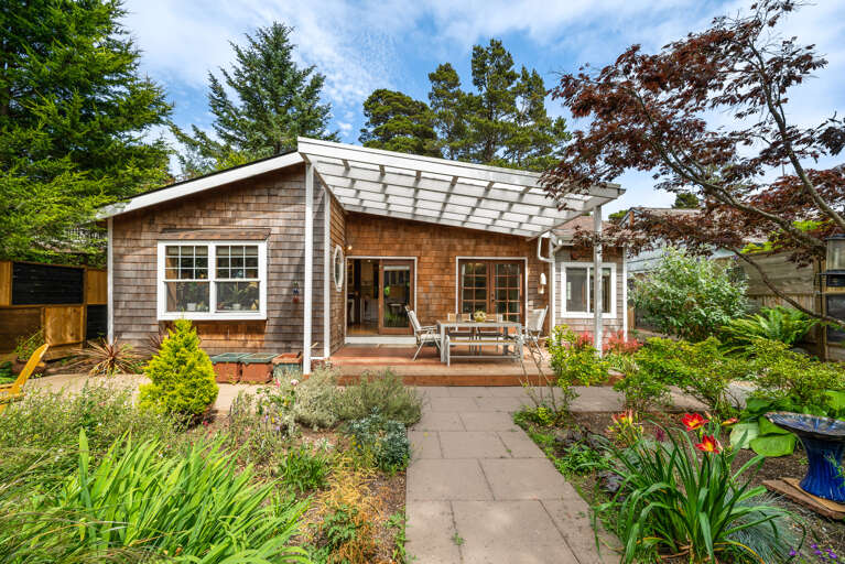 Fenced back yard garden with firepit, hot tub, sauna, covered outdoor dining area