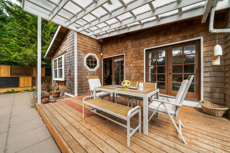 Fenced back yard garden with firepit, hot tub, sauna, covered outdoor dining area