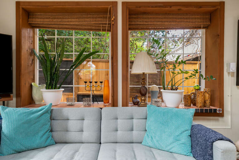 Cozy living room with beautiful views out to the garden area.Open to the dining area. 