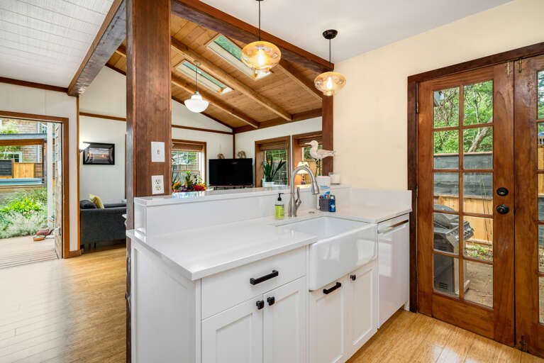 Fully equipped kitchen with side yard access to Gas BBQ. Open to the living area.