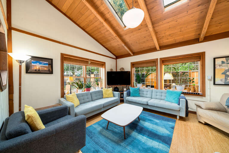 Cozy living room with beautiful views out to the garden area.Open to the dining area. 