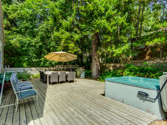 Back deck with outdoor dining for 8 and hot tub.