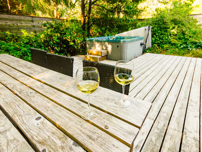 Back deck with dining table and hot tub