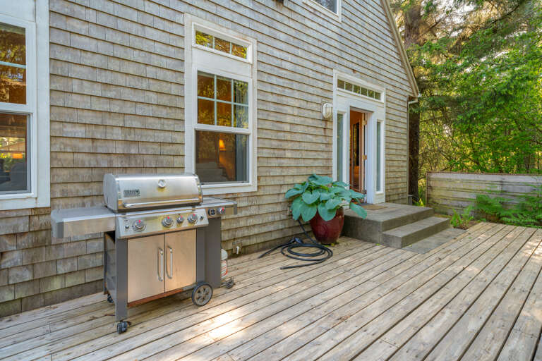 Gas BBQ on the back deck with large table, hot tub, umbrella