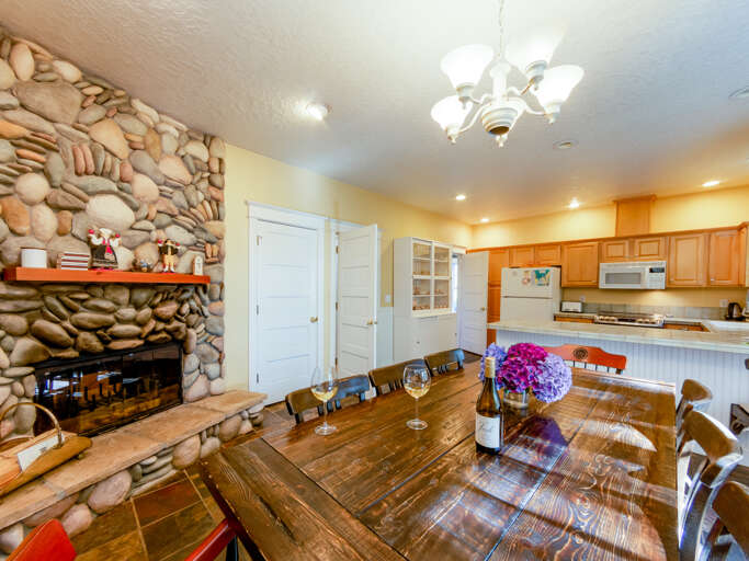 Dining and fully equipped kitchen with pass through double sided fireplace.