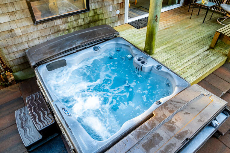 Enjoy relaxing in the private hot tub with the partially fenced back yard area that has golf course greens views.