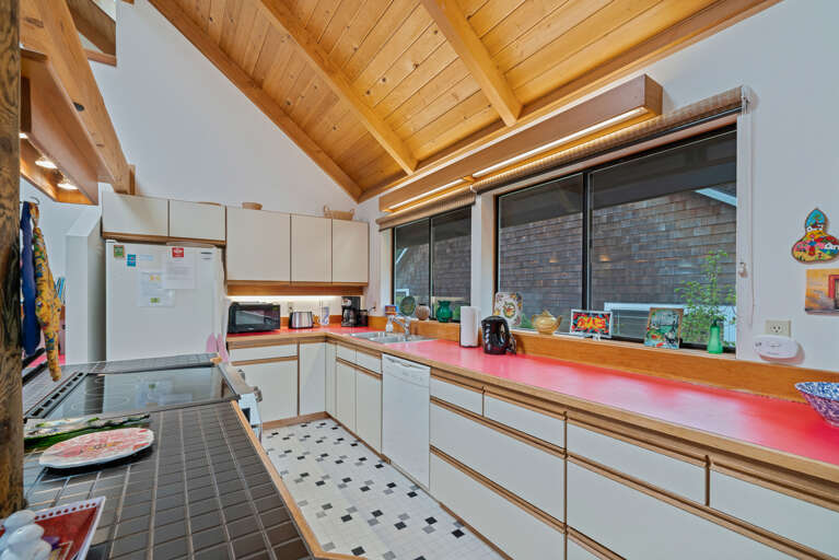 Open living space with fully equipped kitchen with breakfast bar, dining table, Pellet stove. 