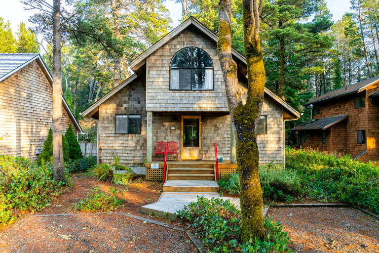 Front of house with a lovely front covered deck. 