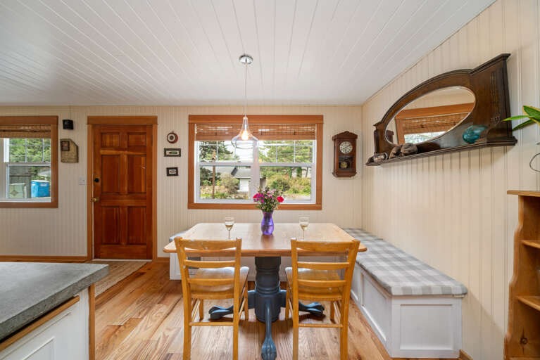 Dining area with bench seating and extra chairs.