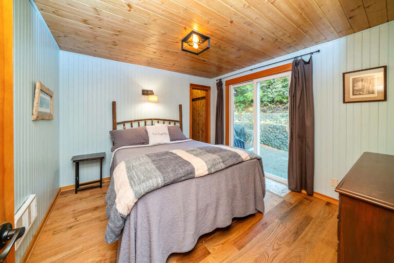 Master bedroom with queen bed and attached bath with walk in shower