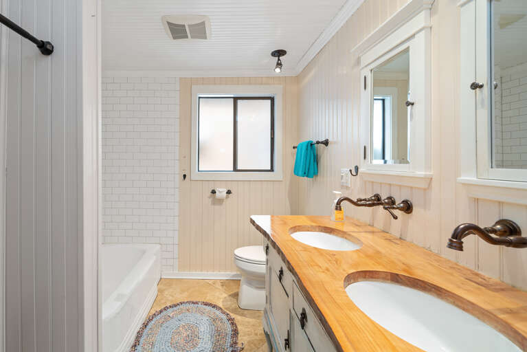 Main bath with double sinks and Shower/ Tub combination. 