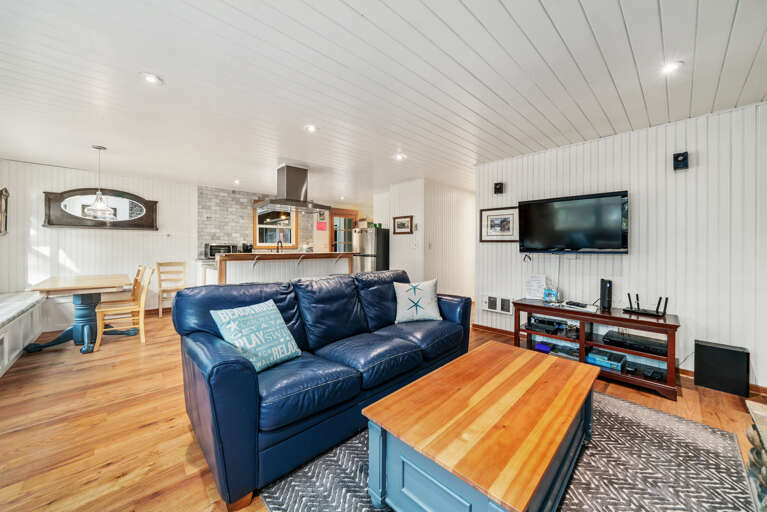 Living room with Roku TV, Fireplace and open to the kitchen and dining area.