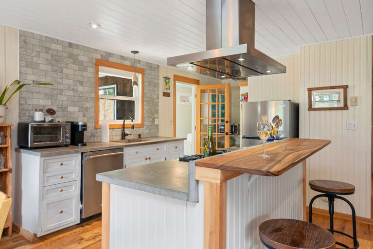 Fully equipped kitchen with Viking stove, Dishwasher, Microwave, Kuerig coffee maker, open to the living and dining area.