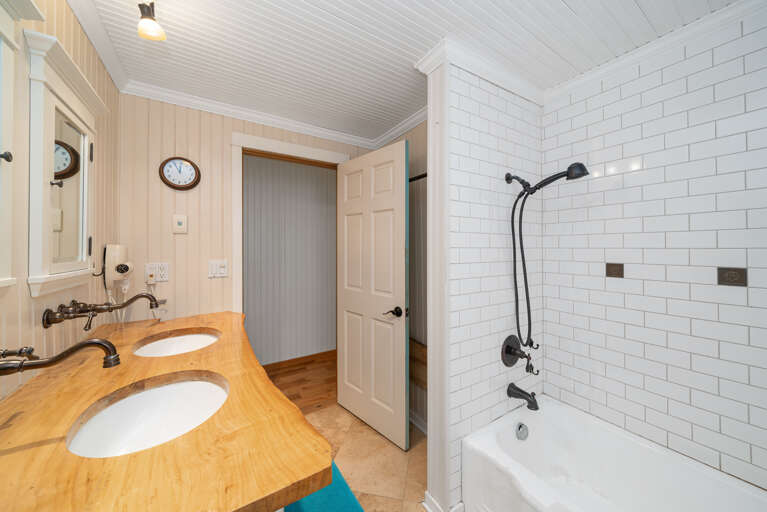 Main bath with double sinks and Shower/ Tub combination. 