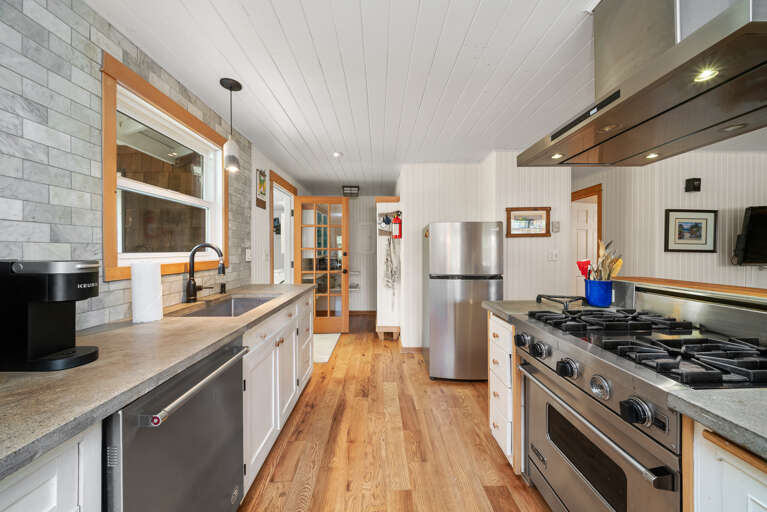Fully equipped kitchen with Viking stove, Dishwasher, Microwave, Kuerig coffee maker, open to the living and dining area.