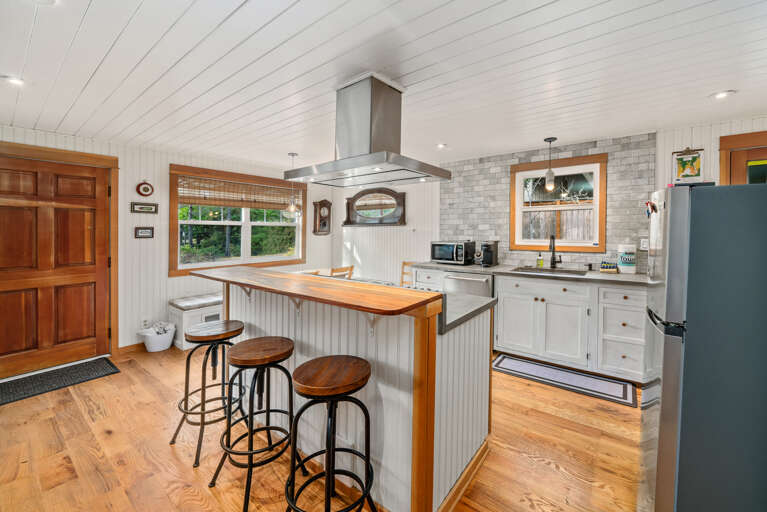 Fully equipped kitchen with Viking stove, Dishwasher, Microwave, Kuerig coffee maker, open to the living and dining area.