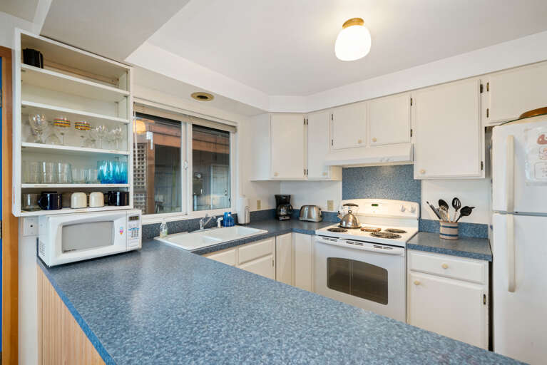 spacious fully stocked kitchen with an electric stove and oven, microwave, toaster, coffee maker and refridgerator. spacious fully stocked kitchen with an electric stove and oven, microwave, toaster, coffee maker and refridgerator.