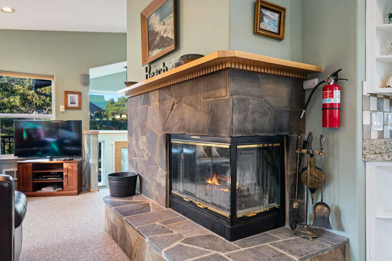 Living room open to dining area. With streaming TV, double sided fireplace (wood not provided)