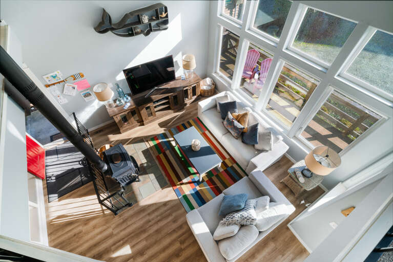 Living room with Wood stove, updated couches and open to dining and kitchen. Smart TV 