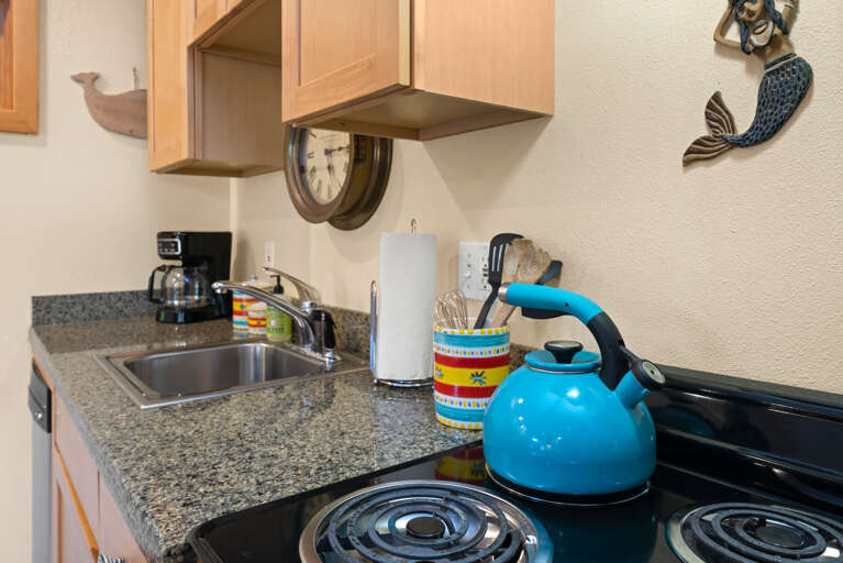 Kitchen with electric stove and oven, automatic dishwasher, refridgerator and coffeepot. Fully stocked.  Kitchen with electric stove and oven, automatic dishwasher, refridgerator and coffeepot. Fully stocked.