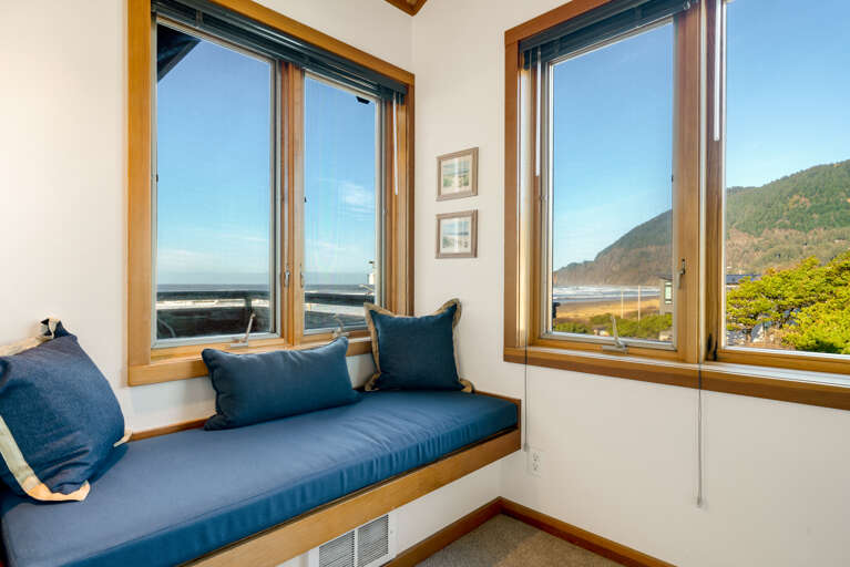 Upstairs master bedroom with Queen bed, ocean and mountain view, attached full bath and window sitting area.  