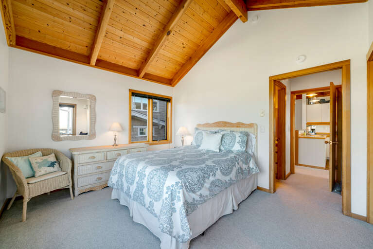 Upstairs master bedroom with Queen bed, ocean and mountain view, attached full bath and window sitting area.  