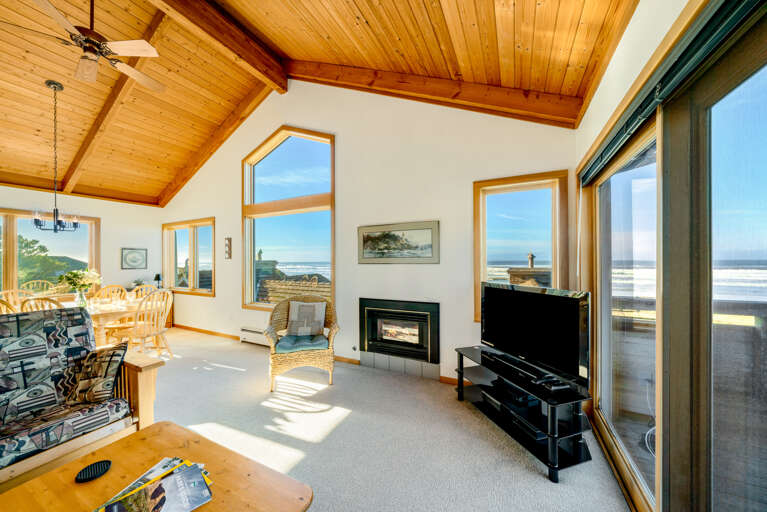 Living area with gas fireplace, Streaming TV, ocean views, Ocean view deck.  Open to the dining room that seats 6. 