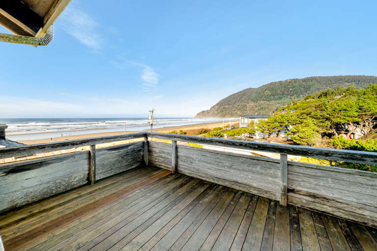 Living room deck with ocean and mountain views