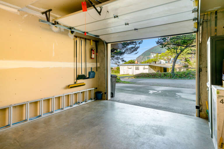 Garage for parking with outdoor furniture and beach toys
