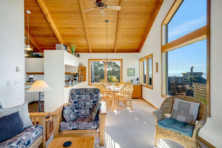 Living area with gas fireplace, Streaming TV, ocean views, Ocean view deck.  Open to the dining room that seats 6. 