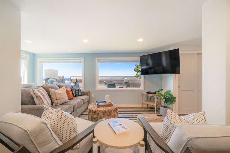Family room on 1st floor with TV, VCR, DVD and Ocean view. 