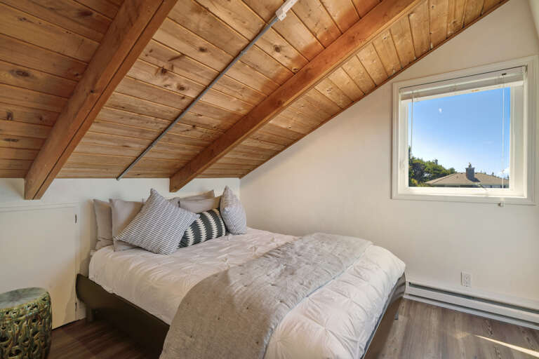 Third floor bedroom with ocean views and queen bed.