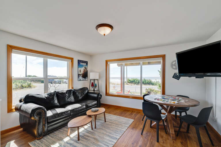 Downstairs den with sofa sleeper, mini fridge, microwave, TV, game table. 