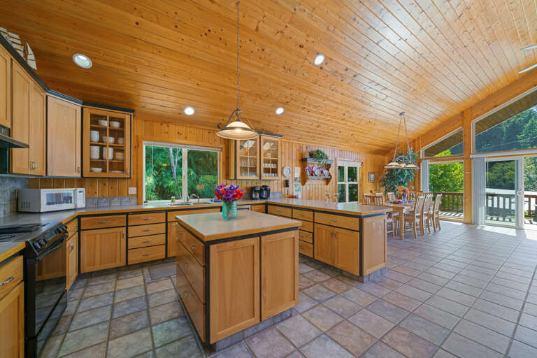 Upstairs fully stocked kitchen with island and breakfast bar, open to  living room with Cable TV, gas fireplace, 2 sleeper sofas and dining area. Access to front deck with BBQ. 